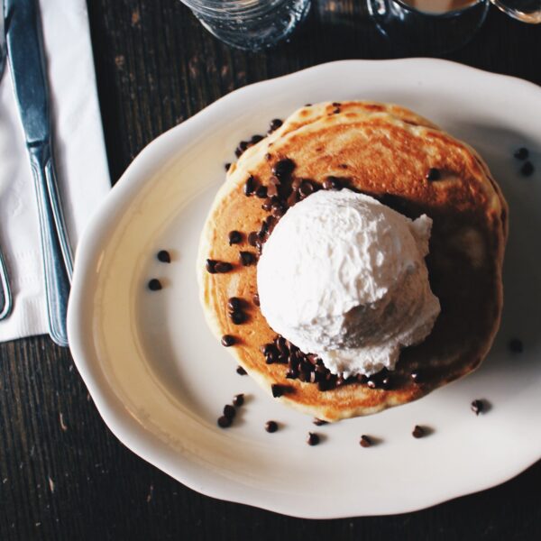 plate of pancakes with ice cream and cacao nibs