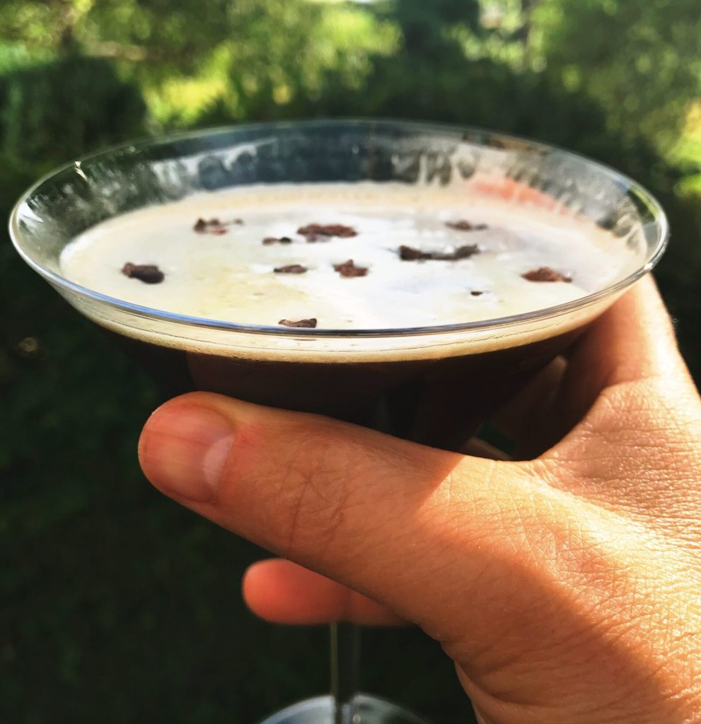 Cacao espresso martini held up in a glass