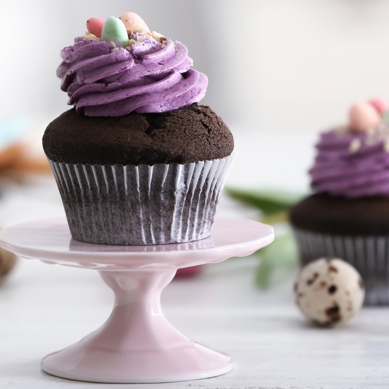 chocolate banana cupcakes decorated with easter eggs and purple frosting